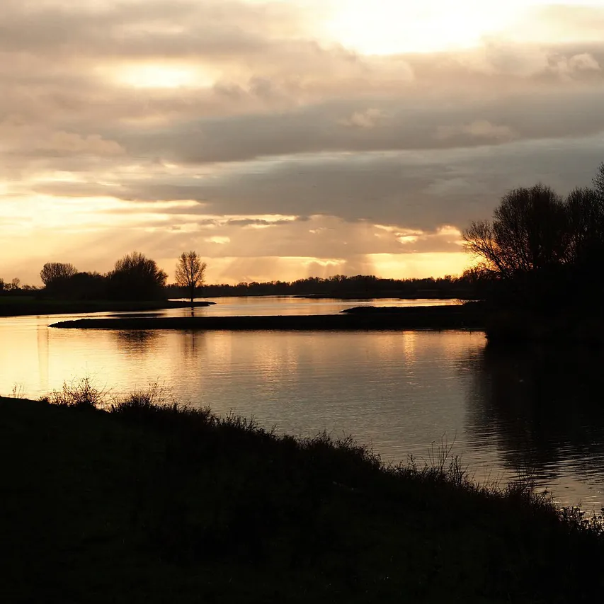 De Rijn bij Wageningen bij zonsondergang: vergelijk de rijscholen in Wageningen